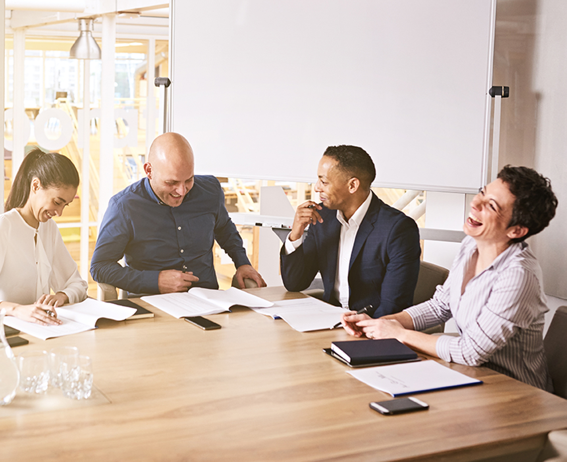 Four people meeting around a table