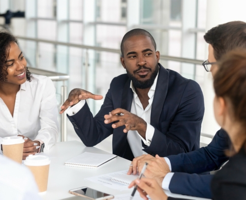 People sitting around a table discussing FSP solutions.