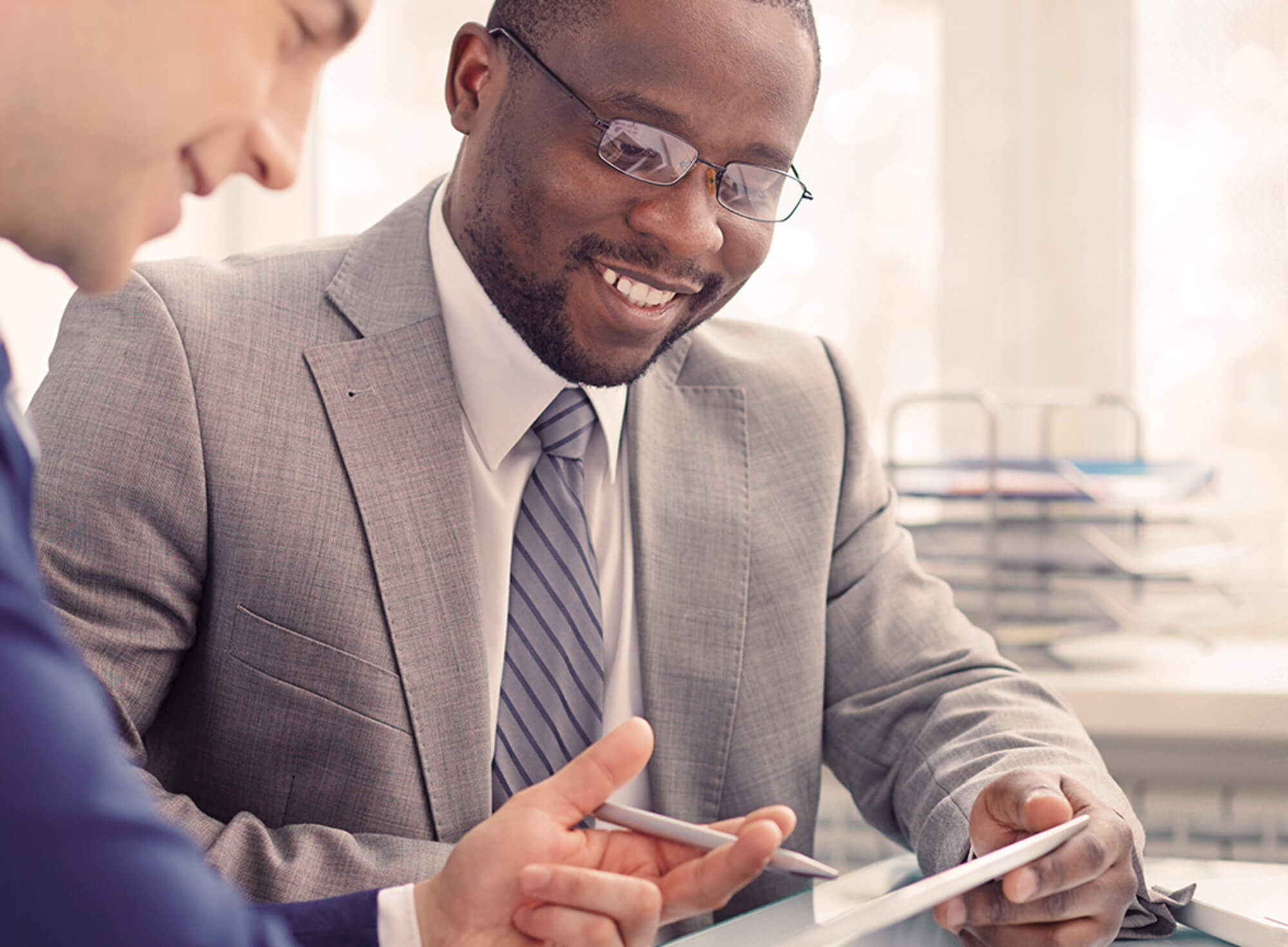 Men collaborating on a tablet