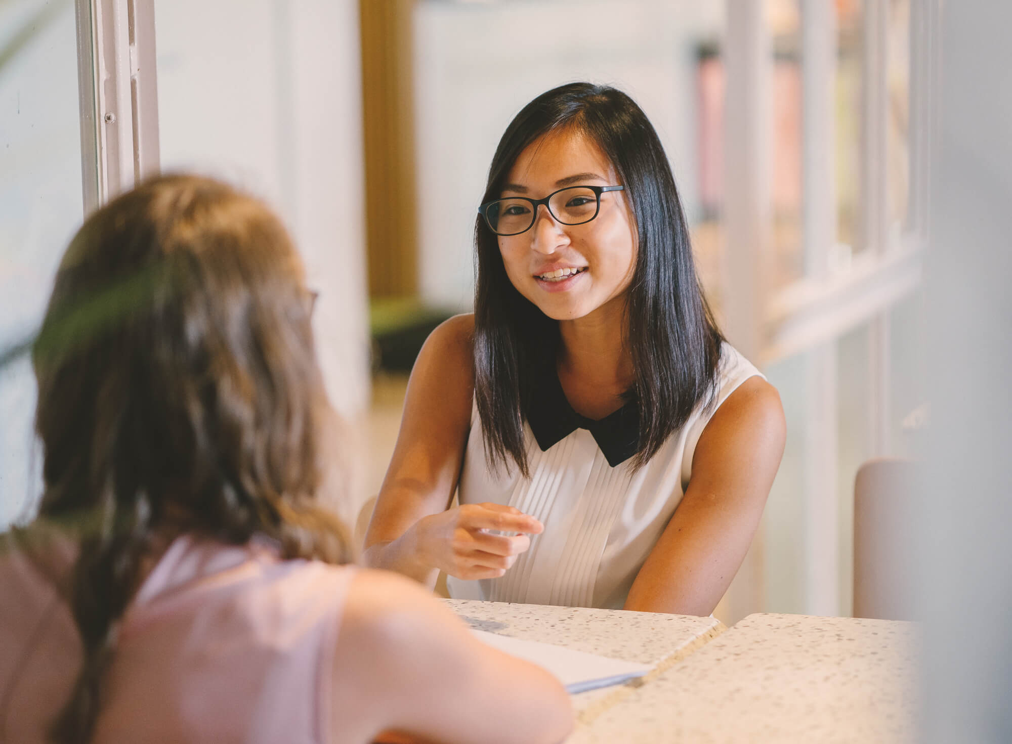 Two people talking at a table