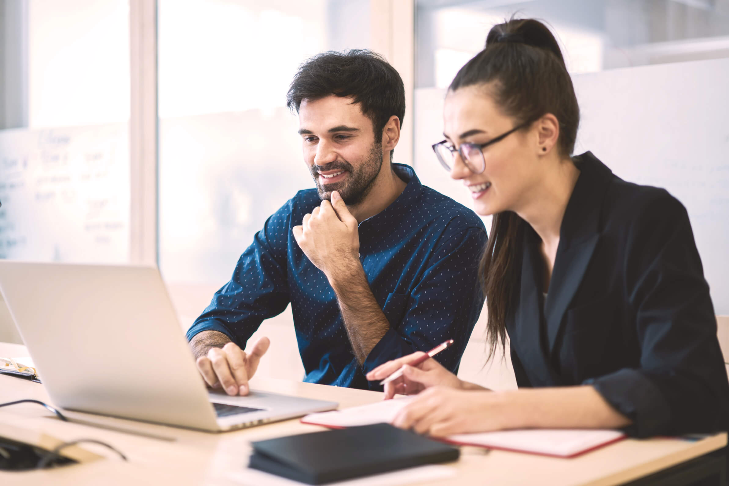 Two people working on a computer